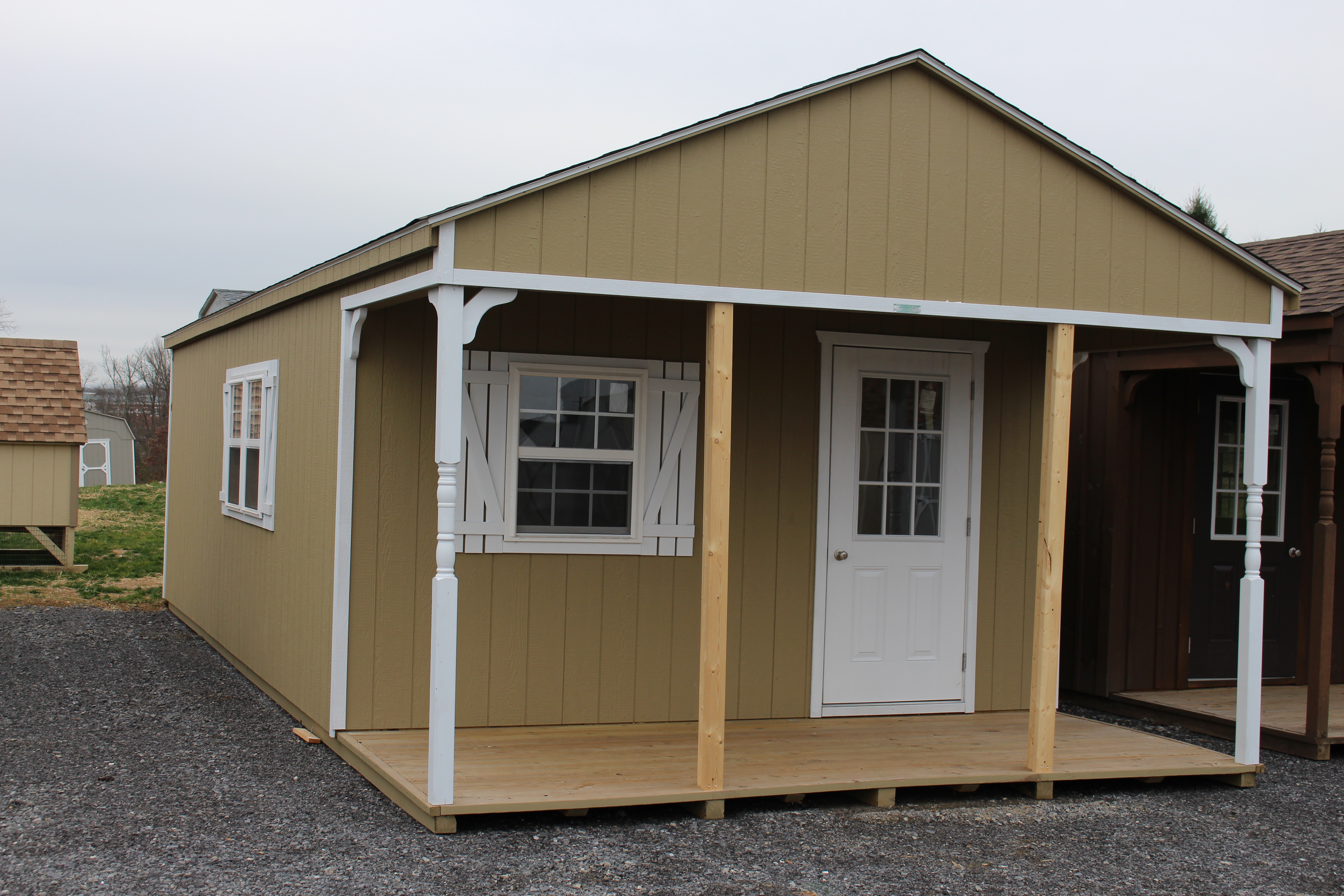 14x32 Peak White Deer Cabin with Buckskin walls, White trim, and shutters, and Barkwood shingles