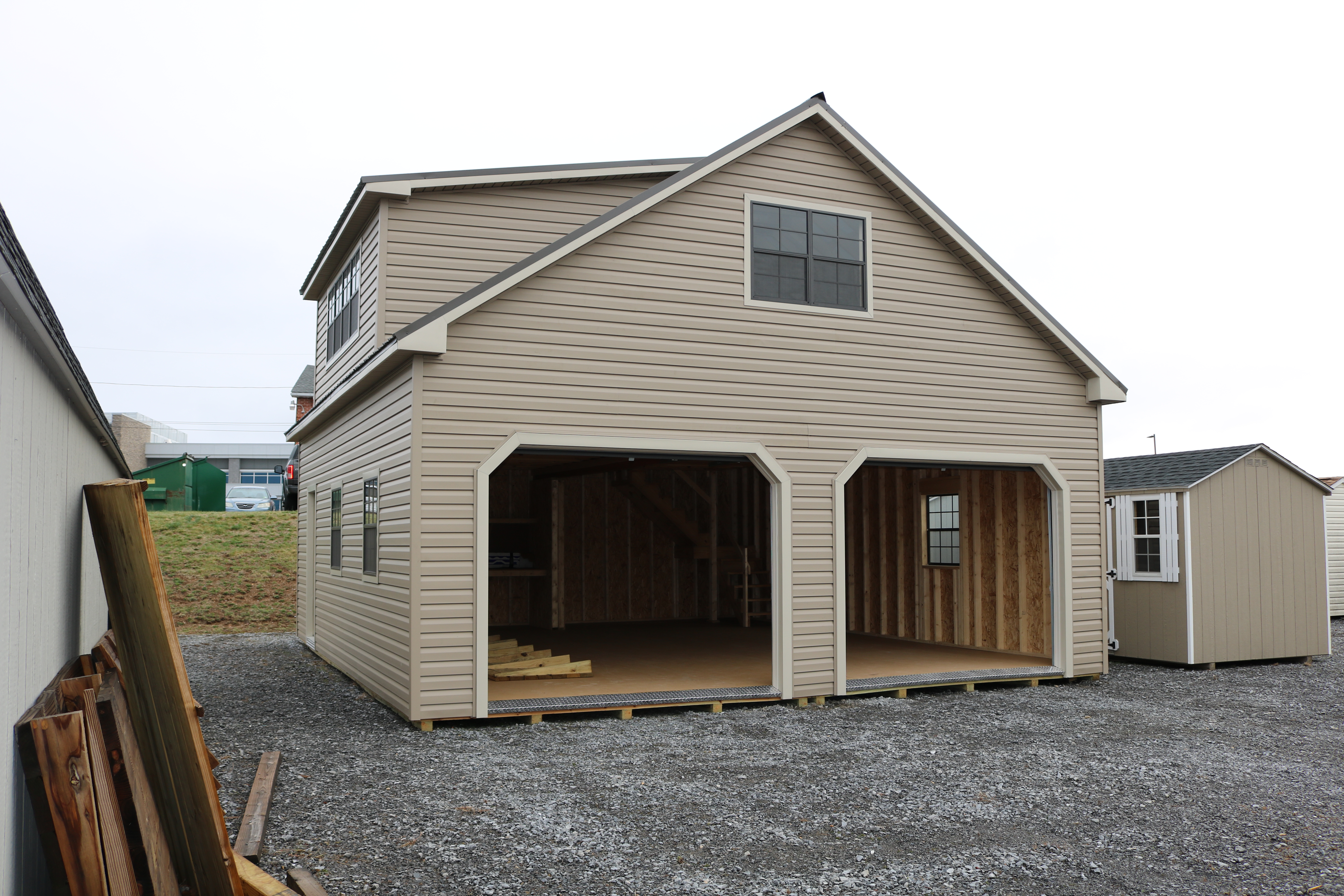 Pine Creek 24x28 Two Story Cape Cod Garage with Artisan Clay walls, Warm Sandalwood trim and Bronze shutters, and Burnish Slate metal roof