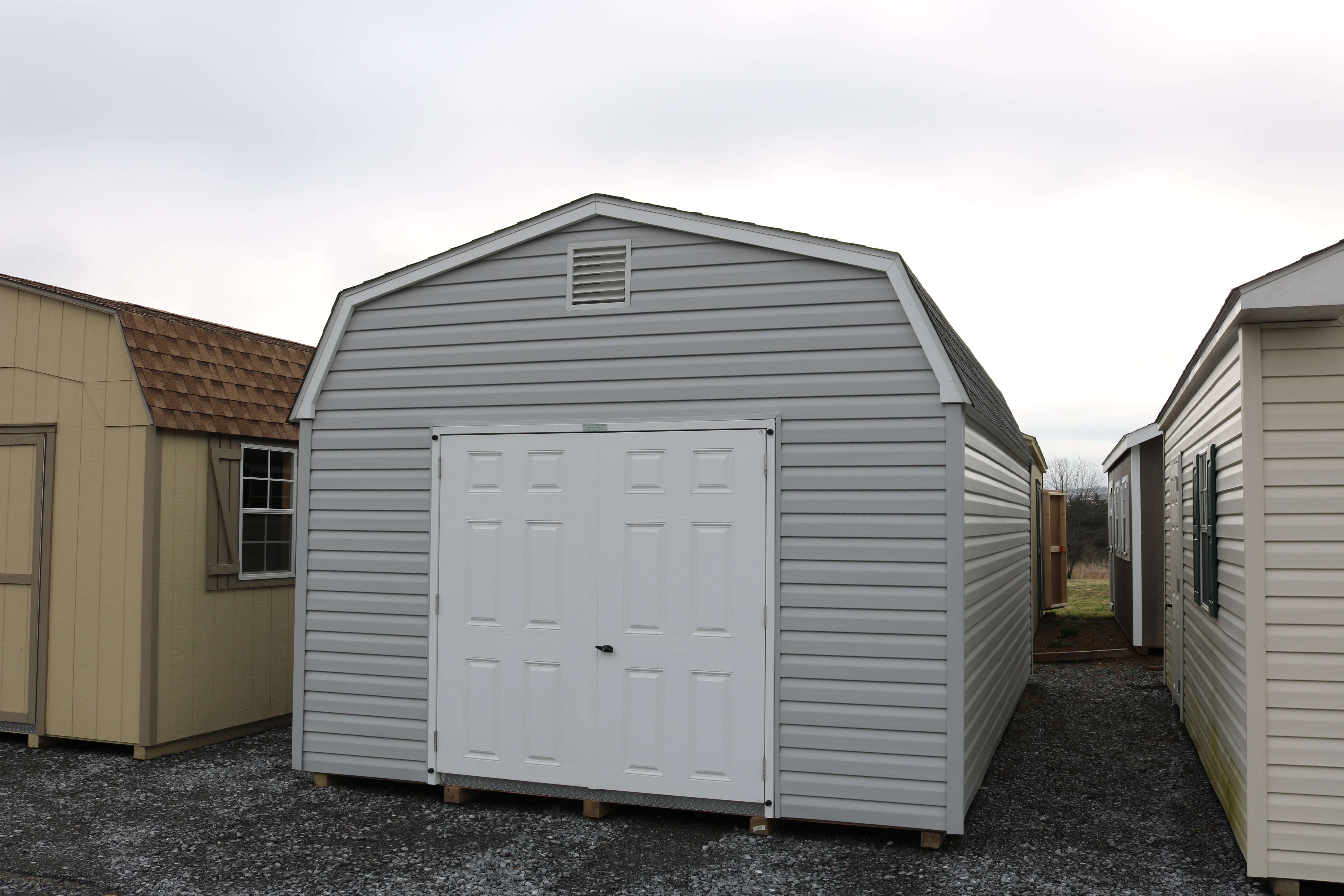 Pine Creek 12x20 HD Dutch Barn Barn with Harbor Stone walls, White trim and Black shutters, and Charcoal shingles